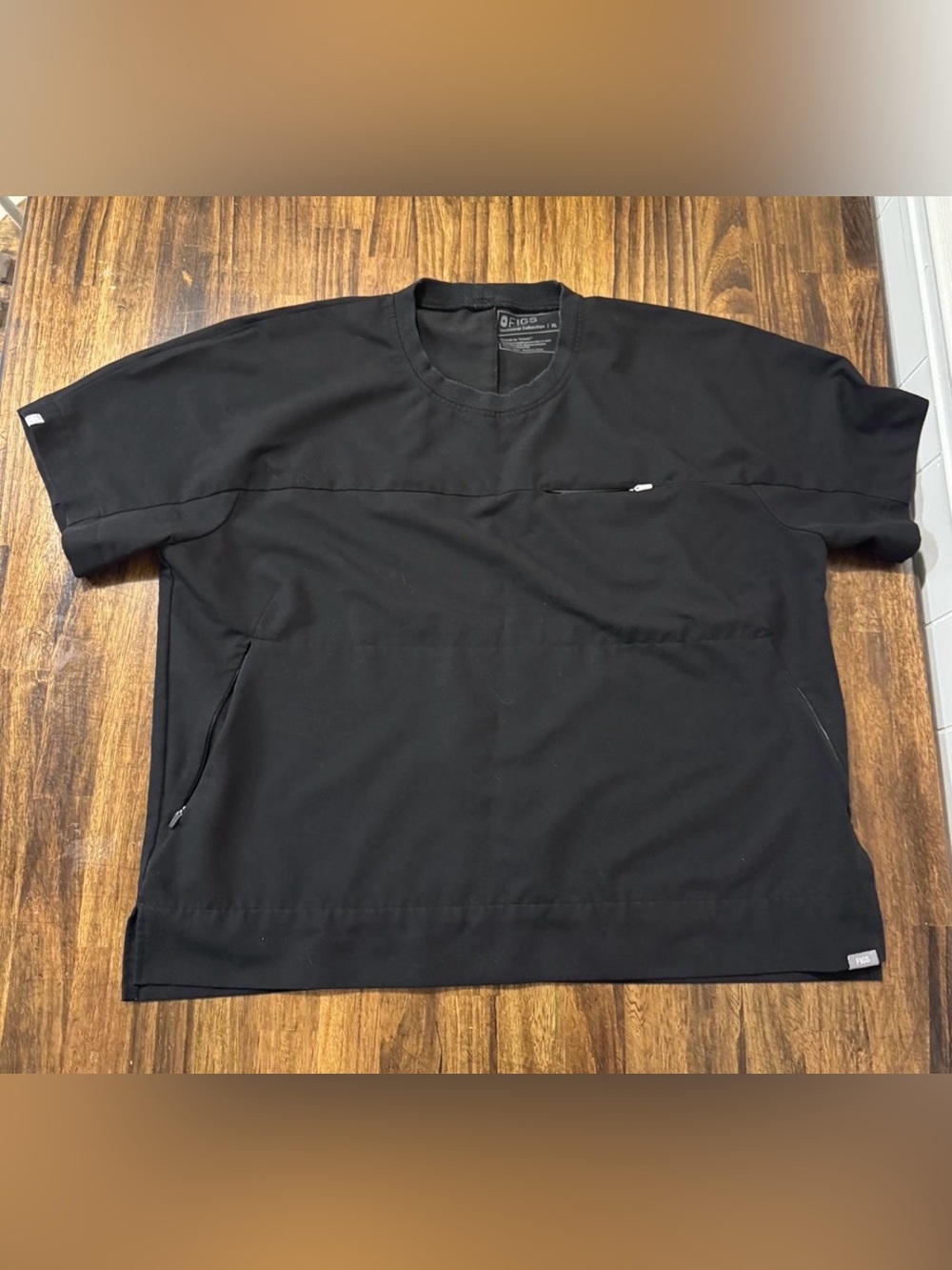 Black FIGS technical collection scrub top with zipper pockets